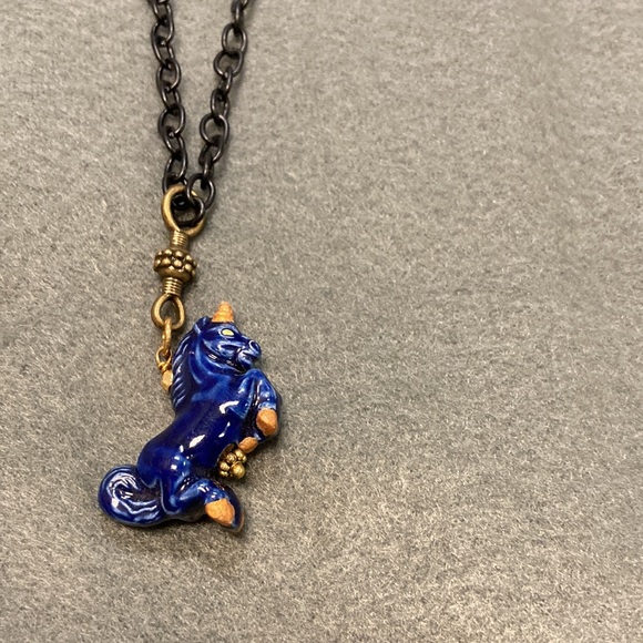 Navel blue unicorn necklace.